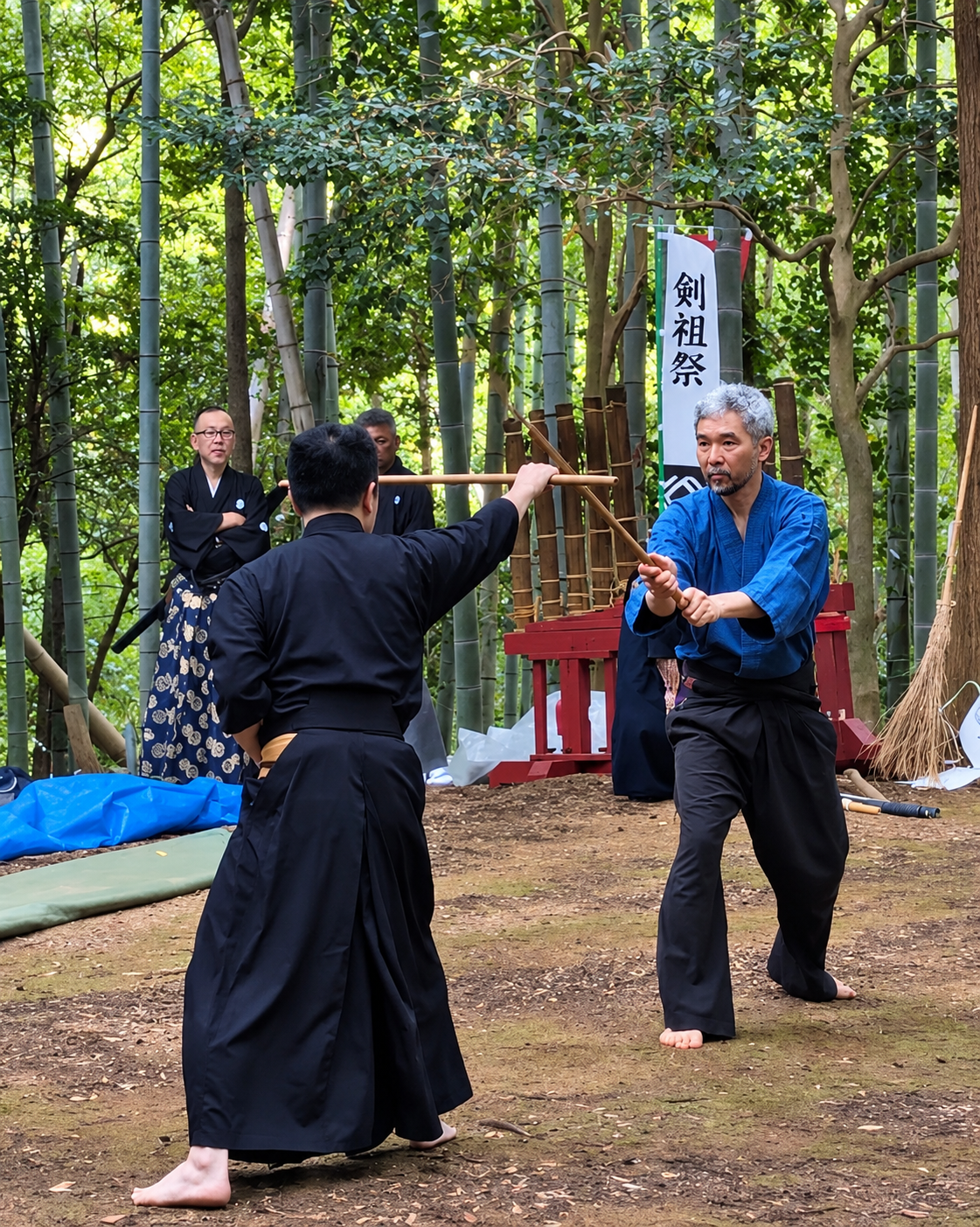Mao Sasaki in blue and an opponent crossing wooden weapons during an embu among bamboo at the Kensosai
